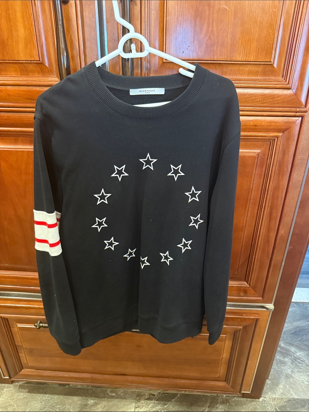 Givenchy Black Crewneck Sweater with White Star Circle and Red-Striped Sleeve